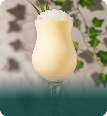 Creamy frozen tropical cocktail with lemongrass garnish