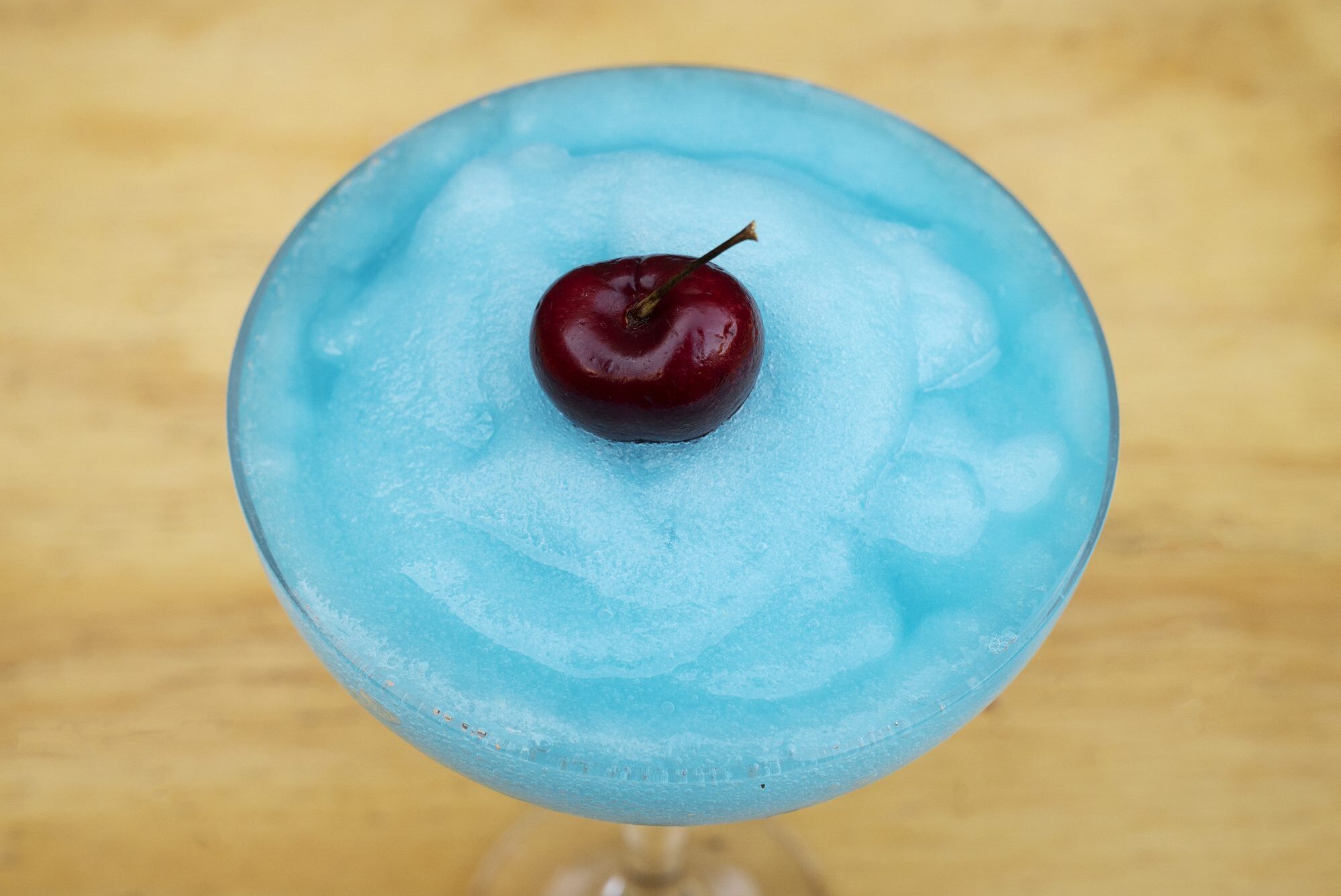 Blue frozen cocktail with cherry