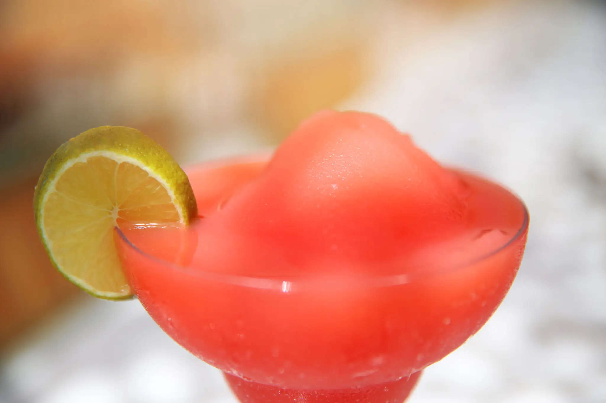 Frozen strawberry margarita with lime garnish